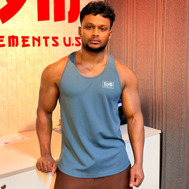 Bangladesh National Team Bodybuilder and brand ambassador, wearing a grey Gym Supplements U.S. tank top.