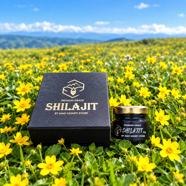 Himalayan Premium Shilajit resin 30g jar and box by Mad Honey Store in a field of yellow flowers