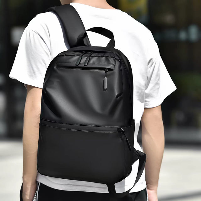 Person wearing the Louis Royaln minimalist black laptop backpack for daily commute, lifestyle back view