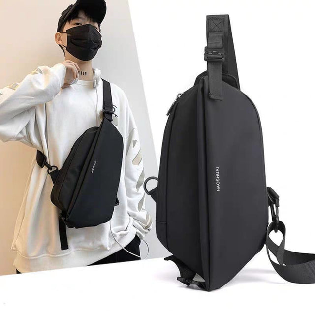 Stylish black men's chest bag worn by a model, showing side-angle design