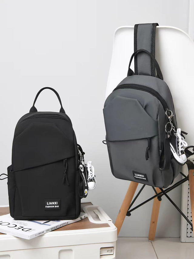 Black and grey LIANXI fashion chest bags for men, side-by-side view, showing durable waterproof material.