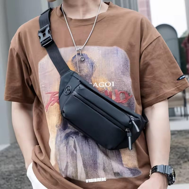 A man wearing a sleek, black minimalist crossbody sling bag, styled for urban streetwear or fitness activities