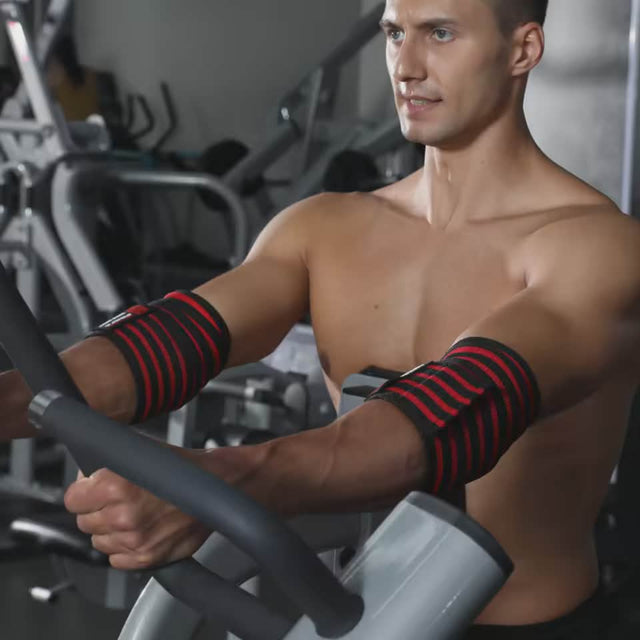 red and black elastic gym elbow protection pads during a weightlifting workout session.