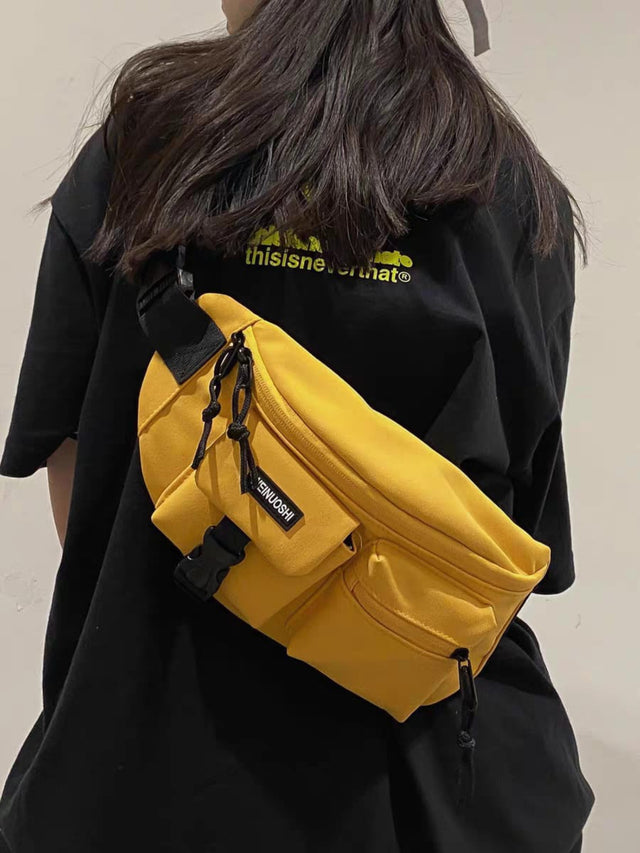 A trendy yellow Japanese aesthetic chest bag worn as a crossbody sling, suitable for men and women.