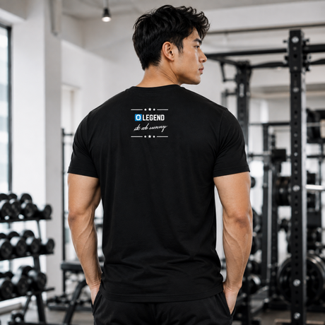 Back view of a muscular male fitness model in a gym wearing a black Gym Supplements U.S t-shirt featuring the custom design "O LEGEND sk ab sunny" printed on the back.