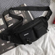Sleek black Japanese aesthetic chest bag, unisex utility sling pack for urban fashion and gym essentials.