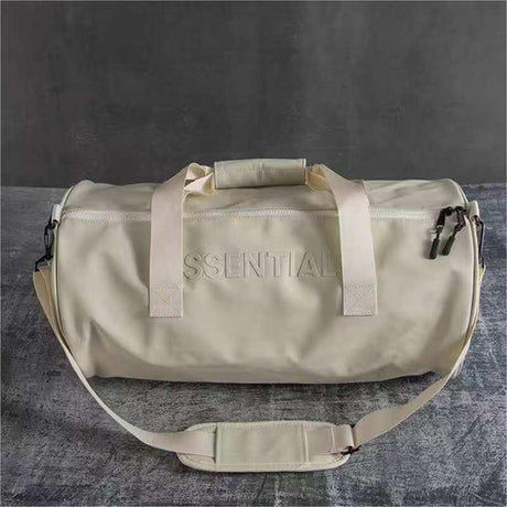 Beige Essential duffel bag with shoulder strap and zipper, ideal for gym, travel, and everyday use.
