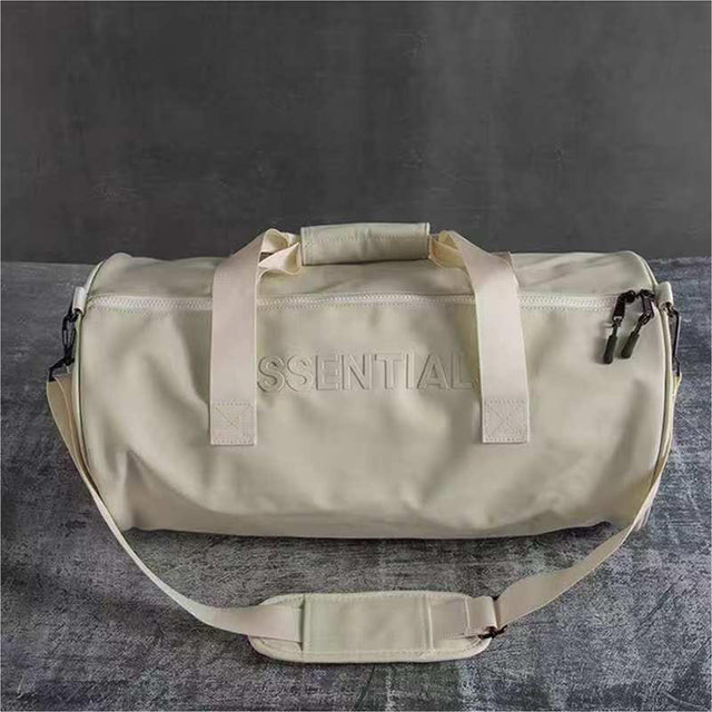 Beige Essential duffel bag with shoulder strap and zipper, ideal for gym, travel, and everyday use.