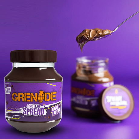 Grenade Protein Spread Hazel Nutter flavor jar with a chocolate hazelnut scoop on a spoon.