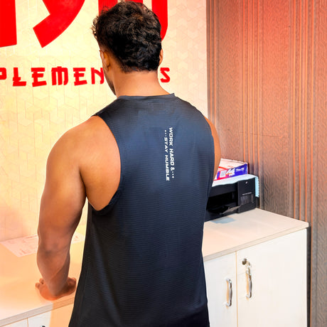 Back view of a black Gym Supplements U.S. sleeveless workout tank featuring the 'Work Hard Stay Humble' slogan