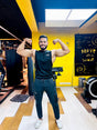 Gym Supplements U.S. brand ambassador wearing a black branded sleeveless fitness shirt in a gym setting