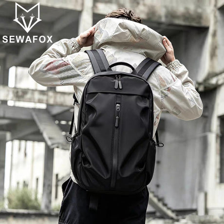 Man wearing a stylish black Sewfox outdoor brand backpack in an urban setting.